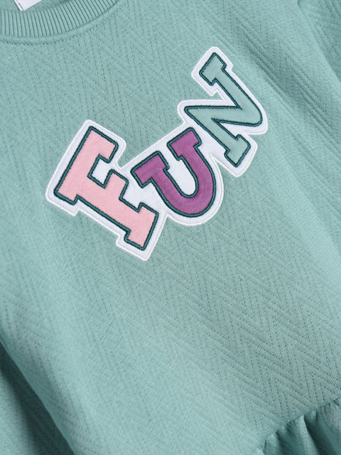 Teal sweatshirt with colorful 'FUN' text on a plain background