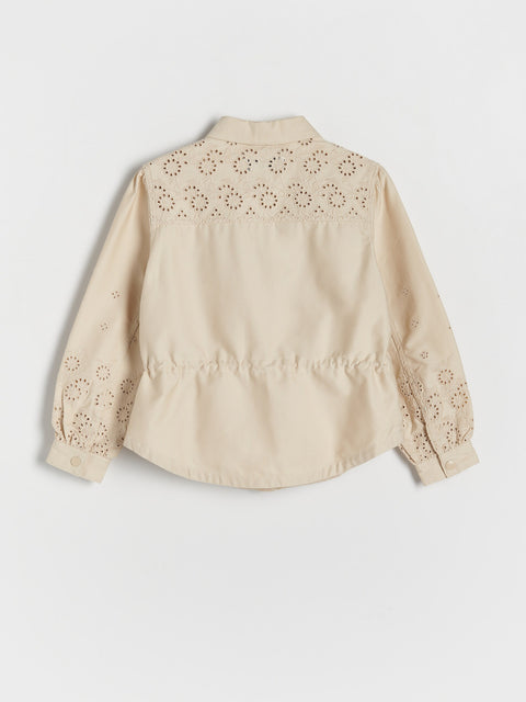 Beige shirt with floral embroidery on a white background