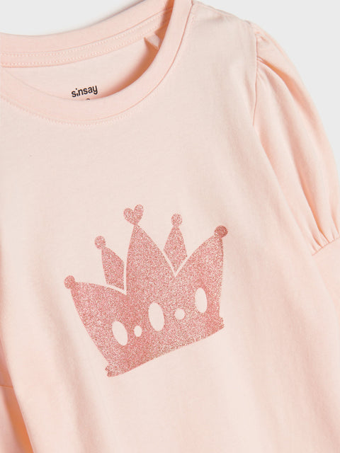 Pink t-shirt with a crown design and 'Snoopy' branding on a light background