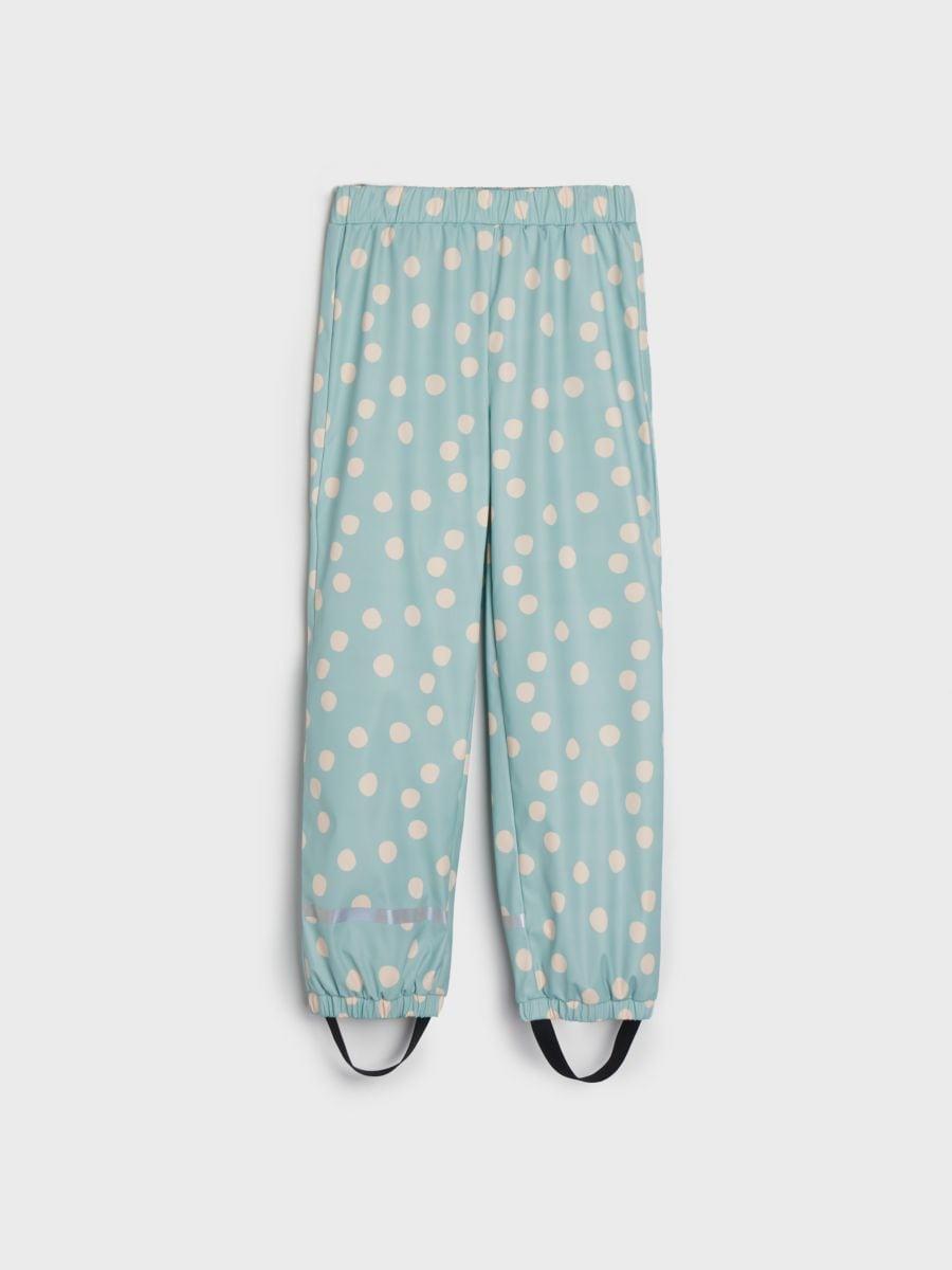 Light blue pants with white polka dots on a white background