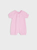 Pink baby romper on a light gray background
