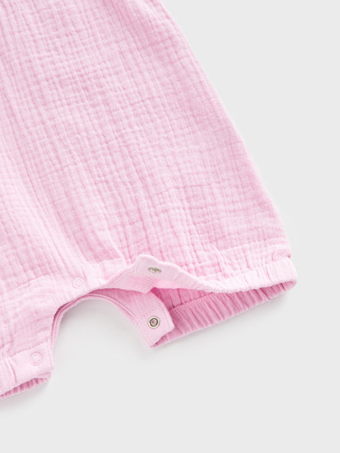 Close-up of a pink textured garment on a light gray background