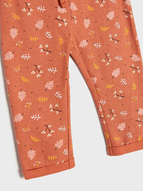 Orange pants with floral pattern on a white background