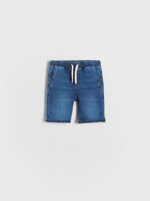 Blue denim shorts on a light gray background