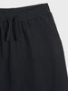 Black pants with a drawstring on a white background