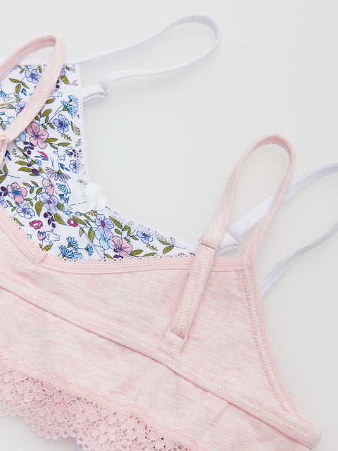 Pink lace-trimmed top with floral trim on a light background