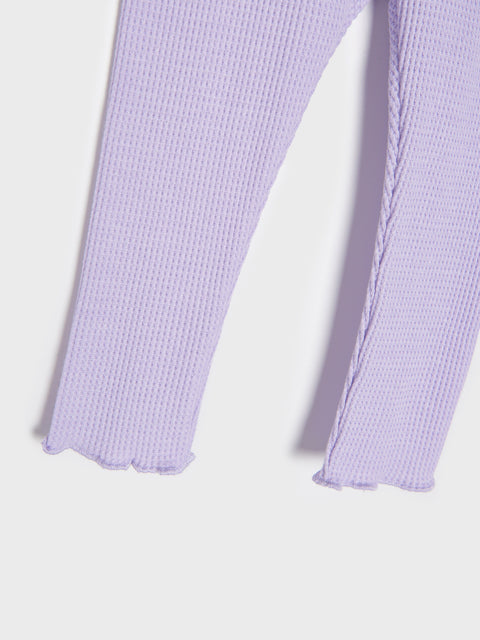 Close-up of lavender ribbed leggings on a light gray background