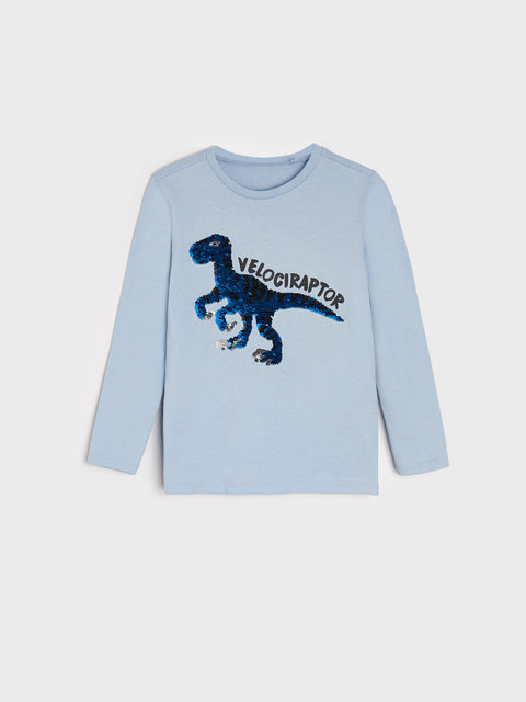 Light blue long-sleeve shirt with a dinosaur graphic and 'Velociraptor' text on a white background