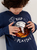 Child wearing a navy blue shirt with a graphic design and text
