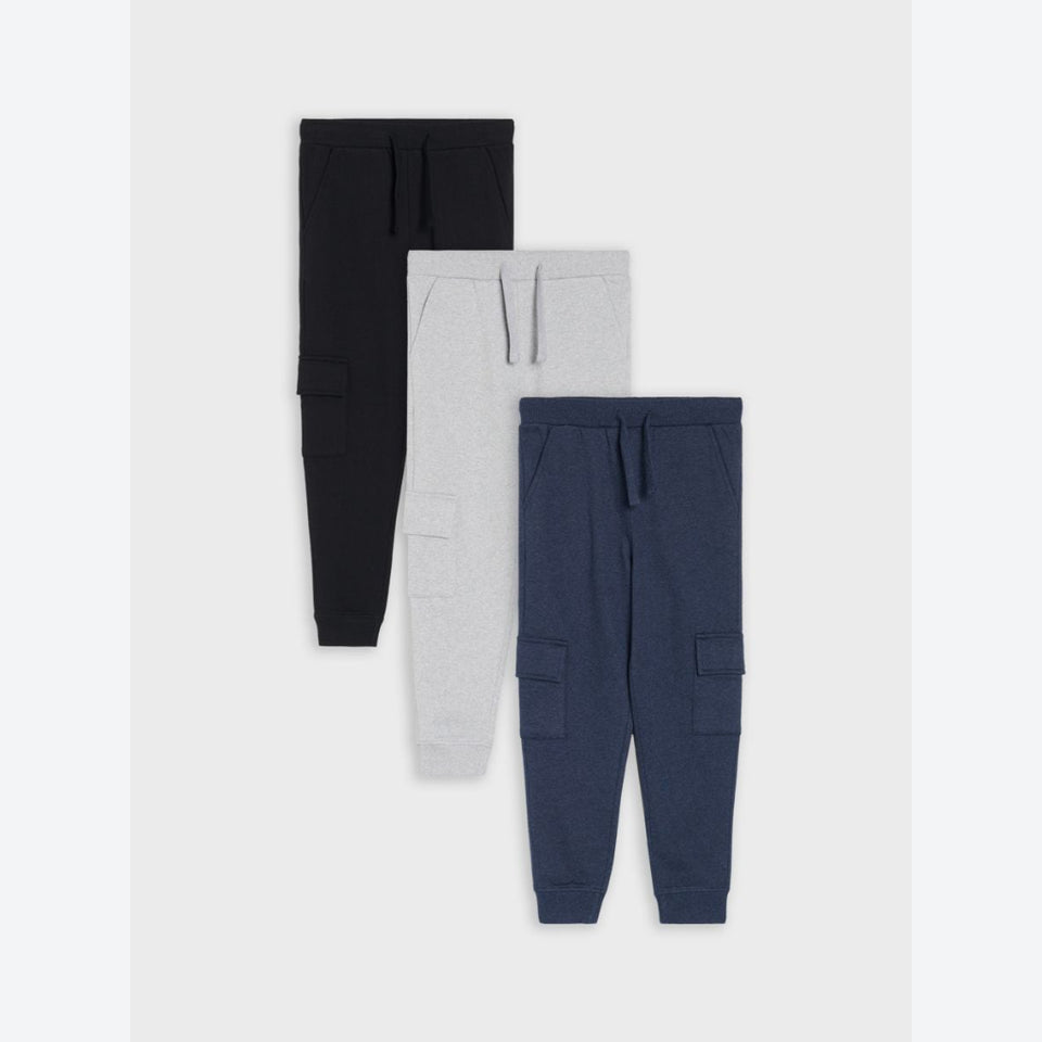 Three pairs of children's cargo jogger sweatpants in black, light gray, and navy blue, arranged vertically on a light gray background.