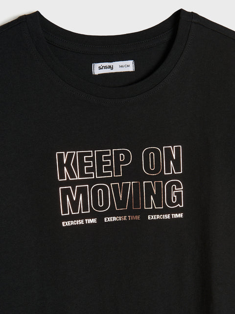 Black t-shirt with 'KEEP ON MOVING' text and Sainsbury's logo.