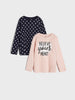 Two long-sleeve shirts, one with polka dots and the other with 'BELIEVE YOUR HEART' text, on a light gray background.