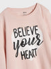 Pink sweatshirt with 'Believe Your Heart' text on a light gray background