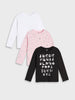 Three long-sleeve shirts in white, pink with floral pattern, and black with alphabet print on a light gray background.