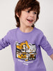 Child wearing a purple long-sleeve shirt with construction vehicle graphics on a plain background