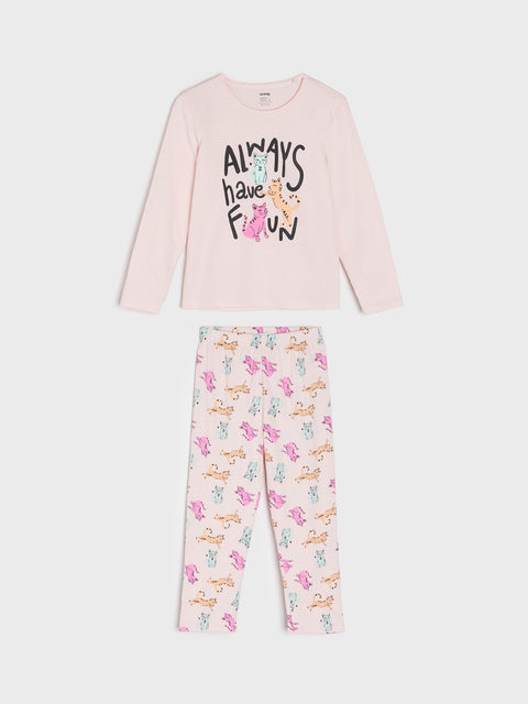 Pink long-sleeve top and pants with dog print on a white background