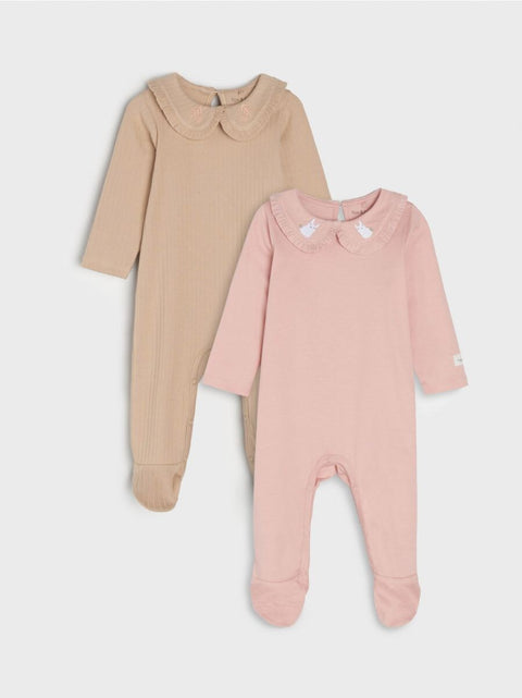 Two baby onesies, one beige and one pink, on a light gray background.