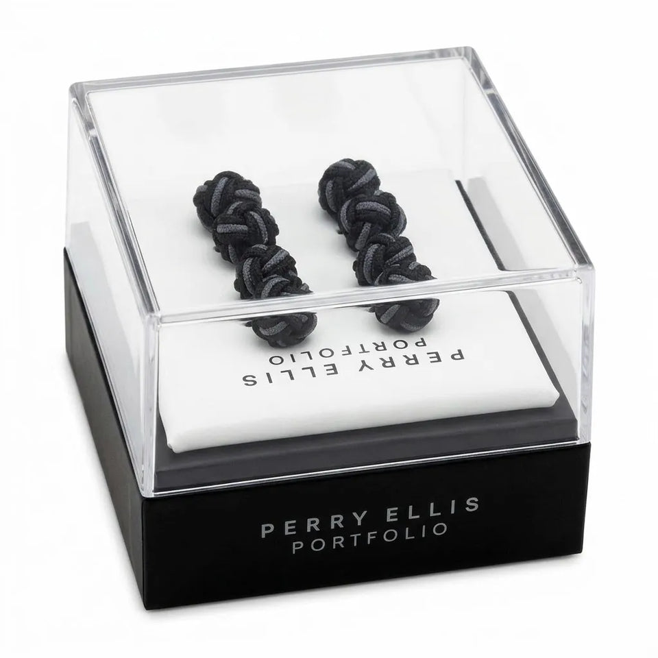 Two black knotted cufflinks displayed inside a clear acrylic presentation box with a black base labeled PERRY ELLIS PORTFOLIO, on a white background.