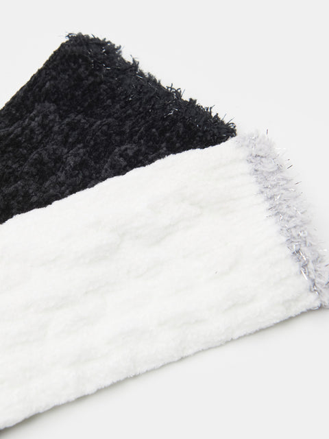Close-up of black and white textured fabric on a light gray background