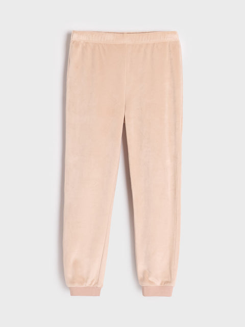 Beige sweatpants on a light gray background