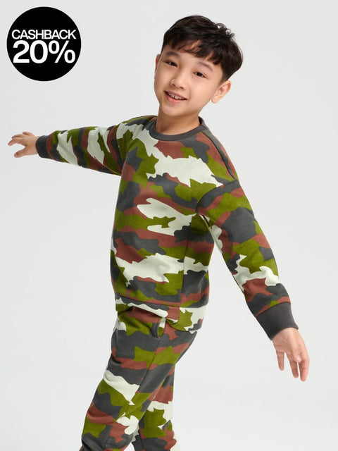 Child wearing a camouflage outfit on a white background