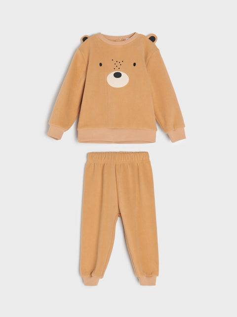 Children's tan pajama set with bear face design on a white background