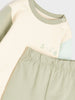 Children's outfit with a shirt and pants in pastel colors on a light background