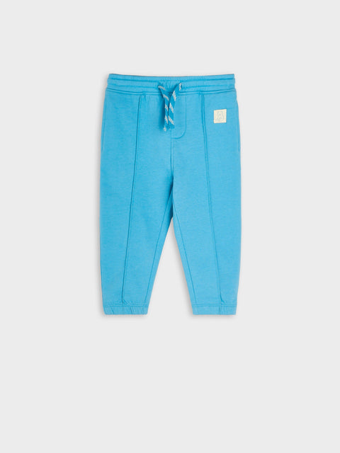 Blue sweatpants with a logo on a white background