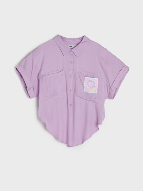 Purple shirt with a pocket and floral design on a light gray background