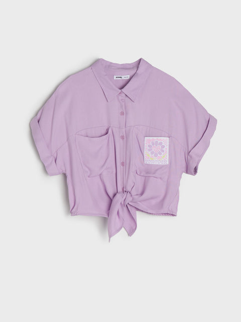 Light purple shirt with a tie front on a light gray background