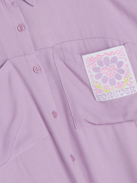 Close-up of a purple shirt with a floral patch and 'Forever' text on the chest pocket.