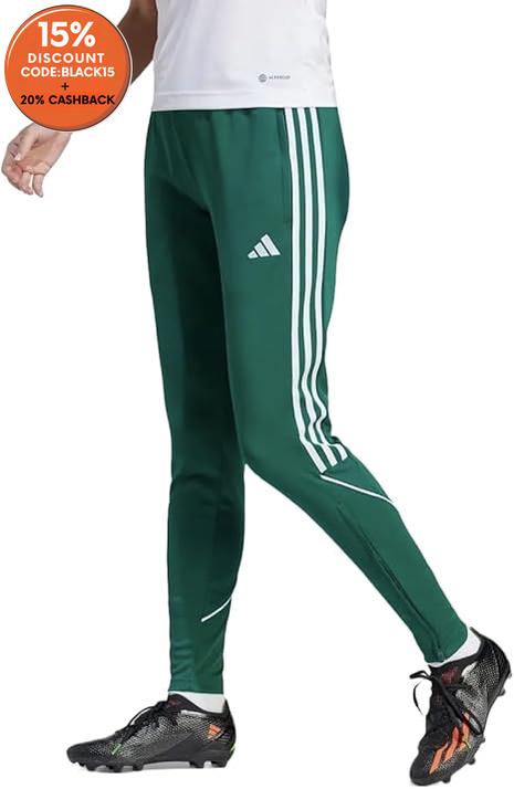 Green Adidas tracksuit pants worn by a person on a white background