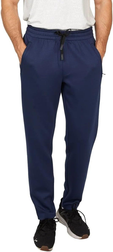 Person wearing navy blue pants with a white shirt and black shoes on a white background