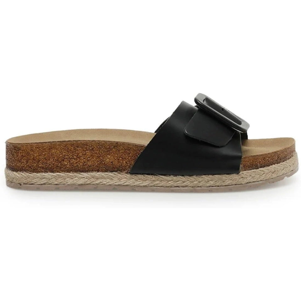 A black leather slide sandal with a wide strap, a black square buckle, a cork midsole, and a braided jute espadrille sole, shown in a side profile on a white background.
