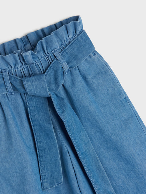 Blue denim skirt with a tie waist on a white background