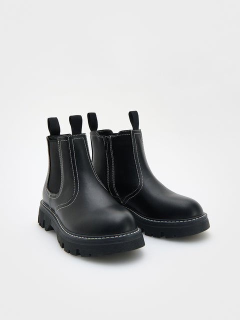 Pair of black Chelsea boots on a white background