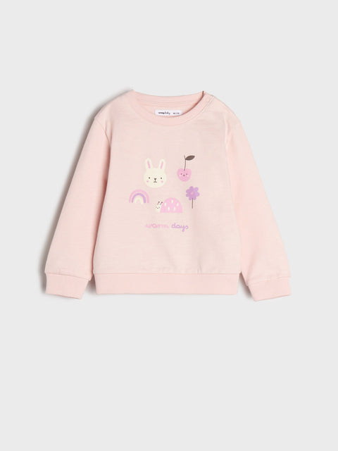 Pink sweatshirt with cartoon designs on a light gray background