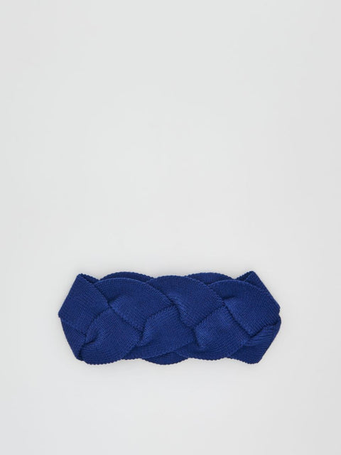 Blue braided headband on a light gray background