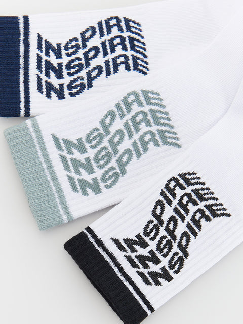Four socks with 'INSPIRE' text in different colors on a white background