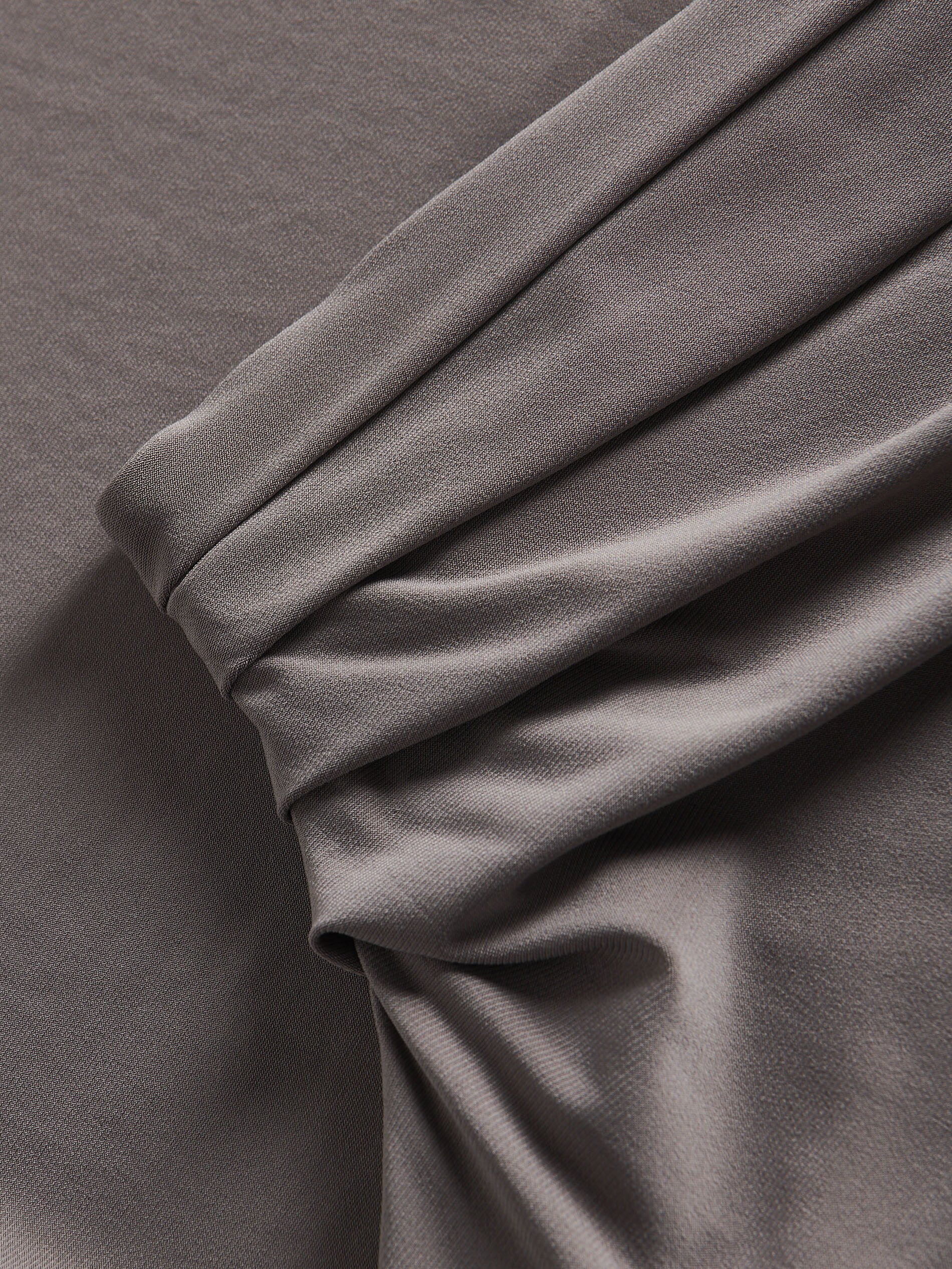 Close-up of gray fabric with folds on a gray background