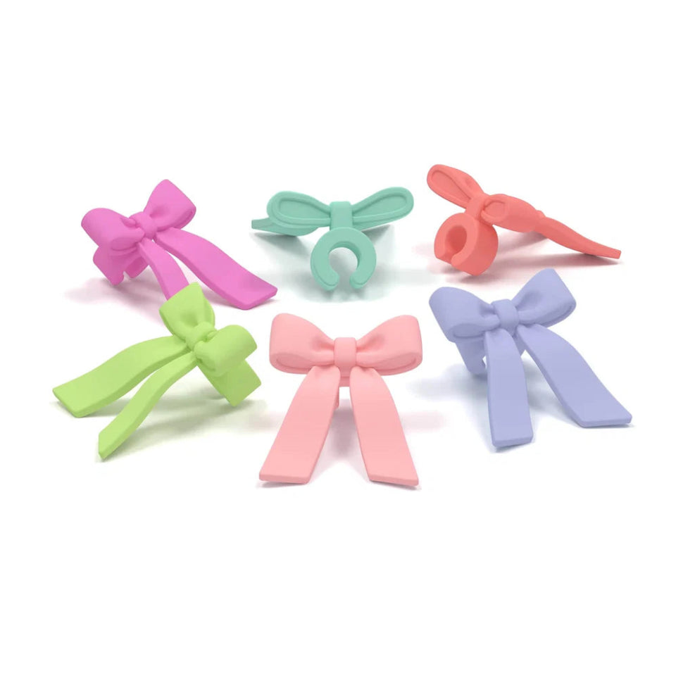 Set of colorful bow-shaped hair clips on a white background