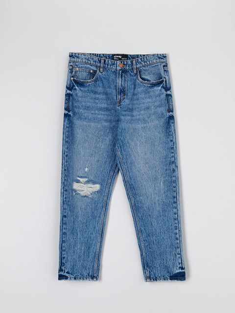 Blue jeans with a slight distressed look on a light gray background