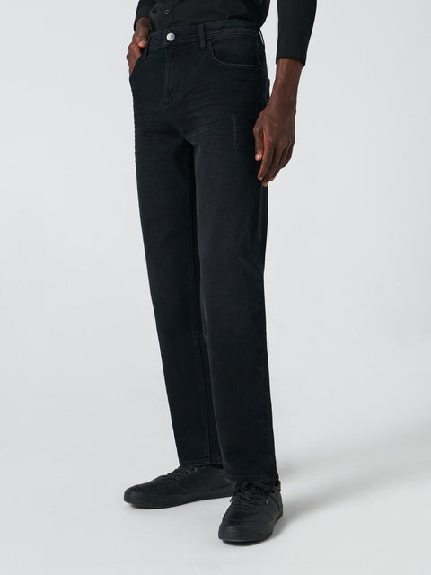 Person wearing black jeans on a white background