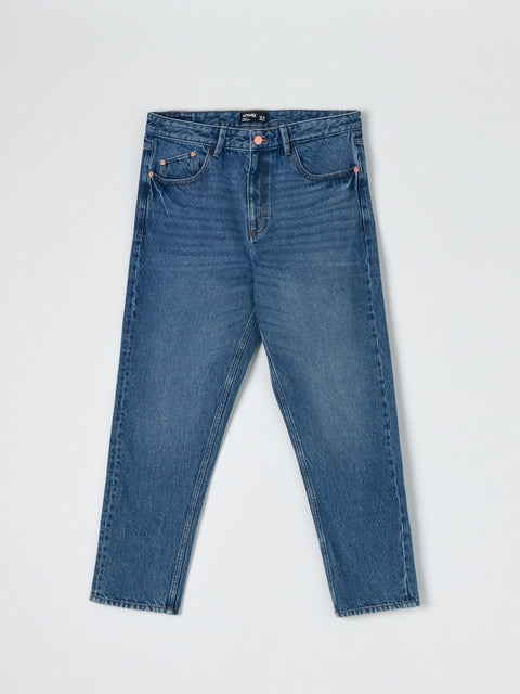 Pair of blue jeans on a light gray background