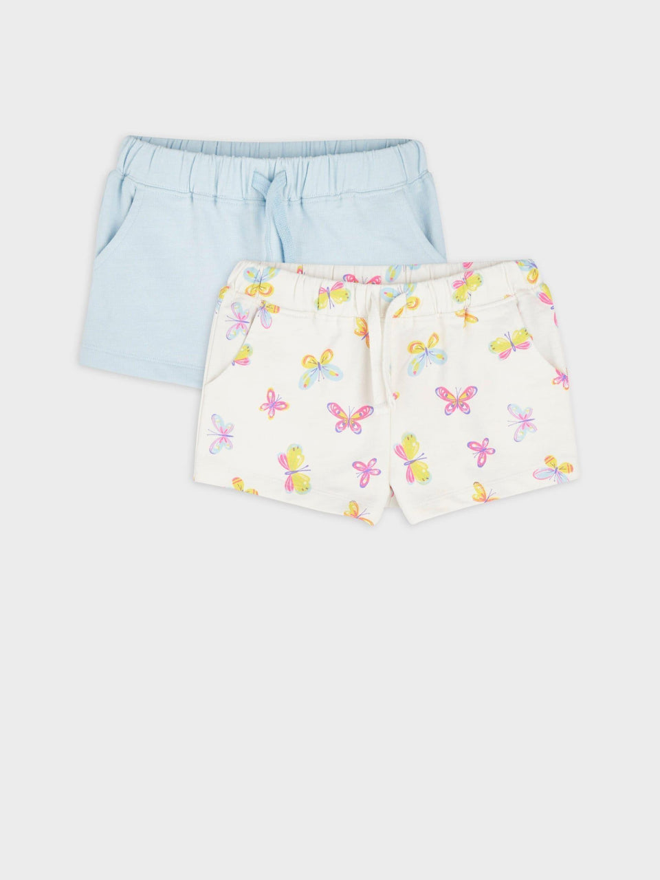 Two pairs of shorts, one light blue and one with butterfly pattern on a white background