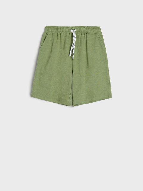 Green shorts with a tie on a white background