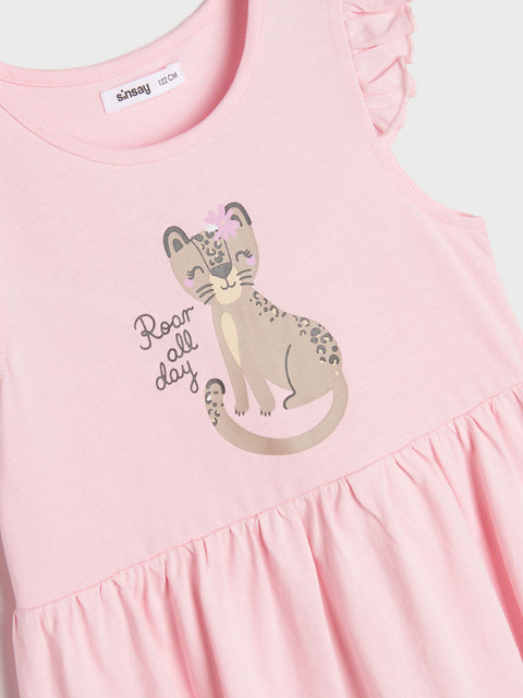 Pink dress with a cat graphic and 'Roar all day' text on a light blue background