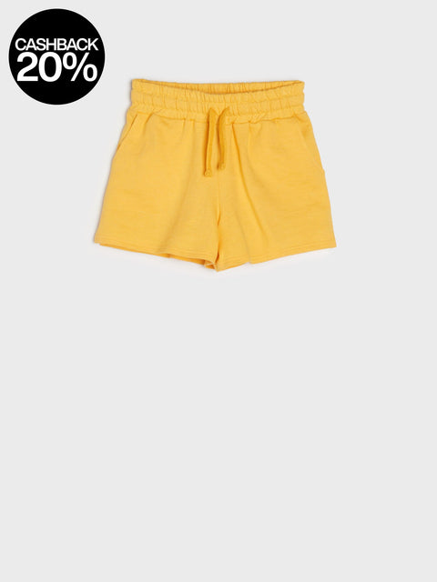 Yellow shorts with a cashback 20% badge on a light gray background