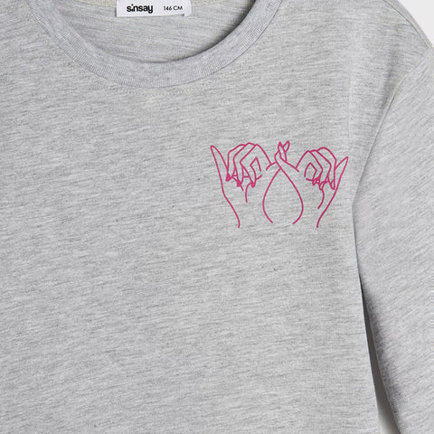 Gray sweatshirt with pink line art design on a plain background