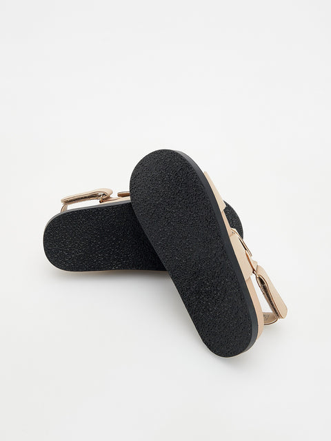 Black shoe insole with rose gold clip on a white background